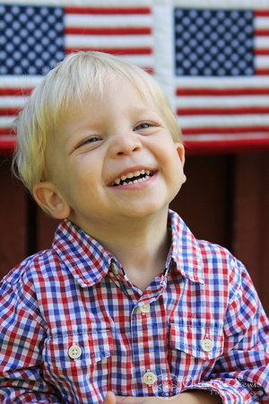 child, portraits, professional, chattanooga, tn, tennessee, patriotic, red, white, blue, american flag, quilt, clothes line, 2 year old, blonde, boy, pictures, photographs, laughing