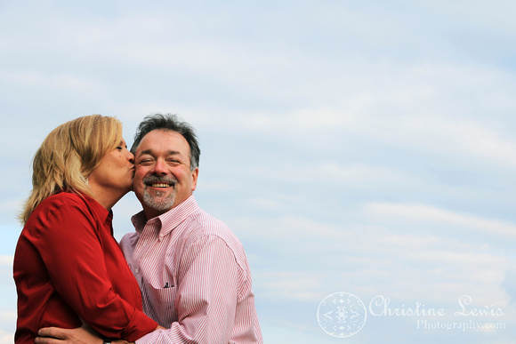 couple, engagement, chattanooga, tennessee, tn, portraits, professional, photographs, pictures, kissing, blue sky, clouds, artistic, on the cheek